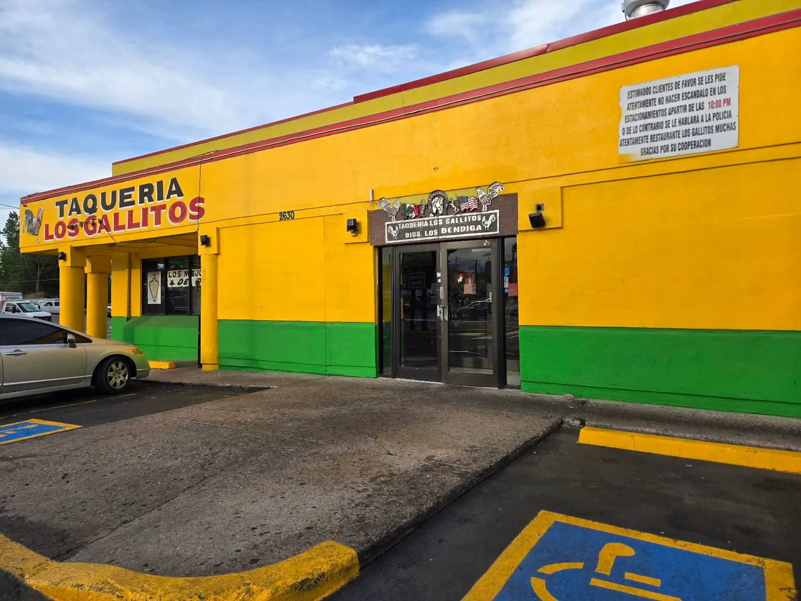 Los Gallitos Taqueria storefront on West Alameda, yellow and green building with the rooster sign