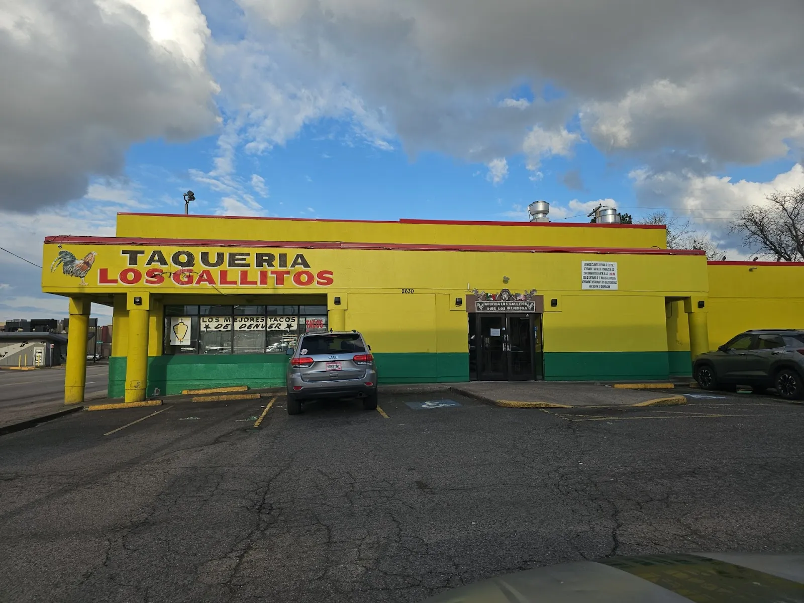 Los Gallitos Taqueria building under a blue sky, with the sign that reads Los Mejores Tacos de Denver